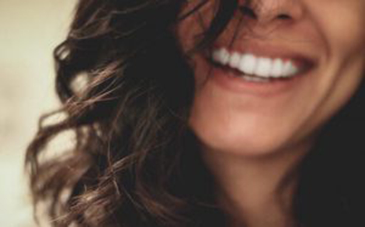 Beautiful smiling woman showing her white teeth